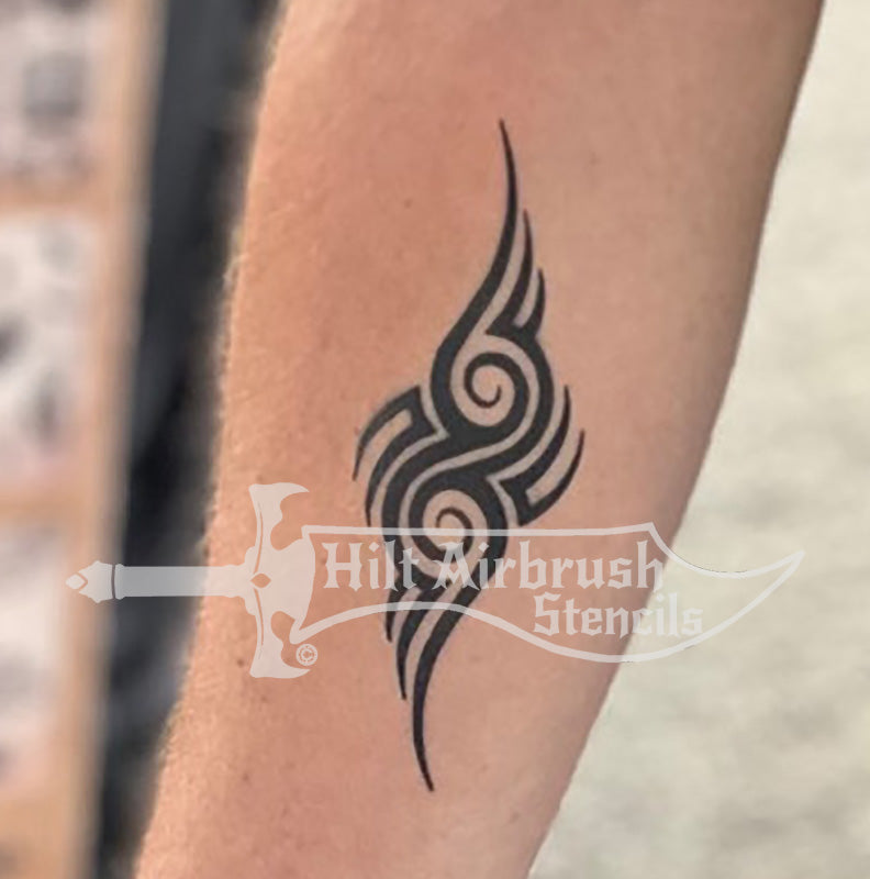 Tattoo of tribal themed design on a person's arm created with a Hilt Airbrush Tattoos stencil.