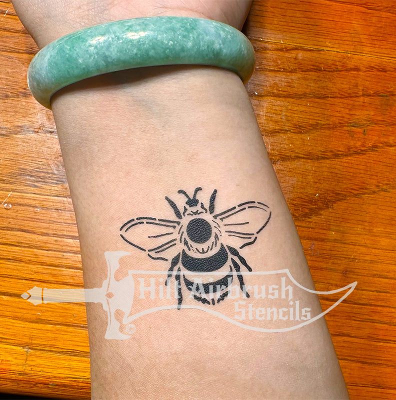 Bumble Bee tattoo on a person's arm with created with a Hilt Airbrush stencil.