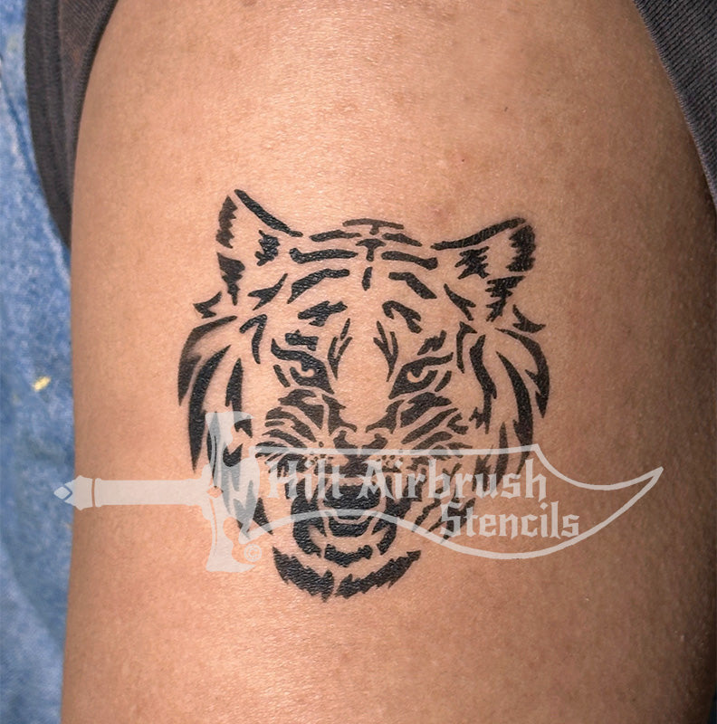 Beautiful tiger stencil tattoo airbrushed on a person's arm designed by Hilt Airbrush Stencils.