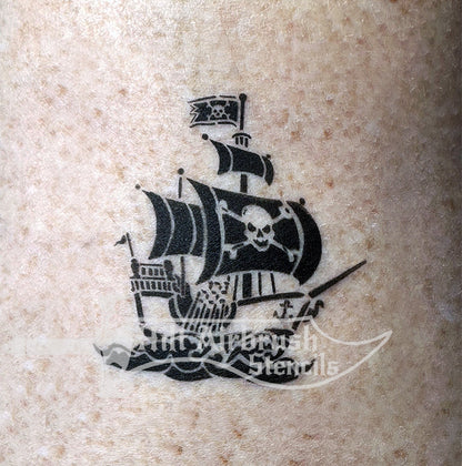 Pirate ship tattoo airbrushed on someone with skull and crossbones flag.