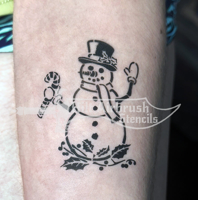 Snowman tattoo airbrushed on a person's arm, created with a Hilt Airbrush tattoo Stencil.