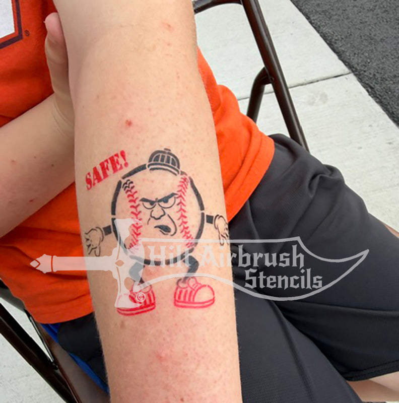 A temporary tattoo of a cartoon baseball umpire with the word 'SAFE!' created with a Hilt Airbrush Stencil.