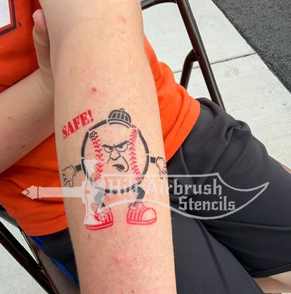 A temporary tattoo of a cartoon baseball umpire with the word 'SAFE!' created with a Hilt Airbrush Stencil.