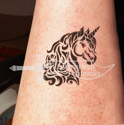 Airbrush tattoo of a fancy unicorn design sprayed on a person's skin created with a stencil from Hilt Airbrush Stencils.