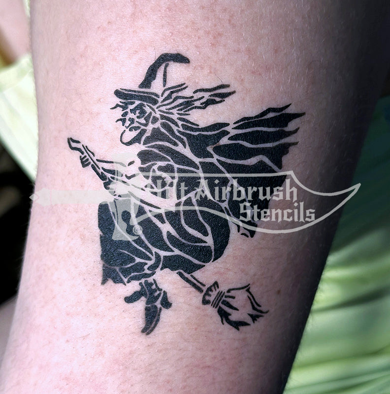 Black witch airbrush tattoo on a person's arm created with a Hilt Airbrush Stencil