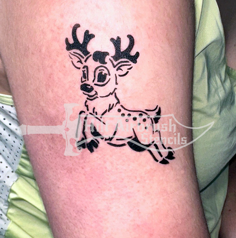 Cartoon reindeer tattoo airbrushed on a person's arm created with a Hilt Airbrush tattoo Stencil
