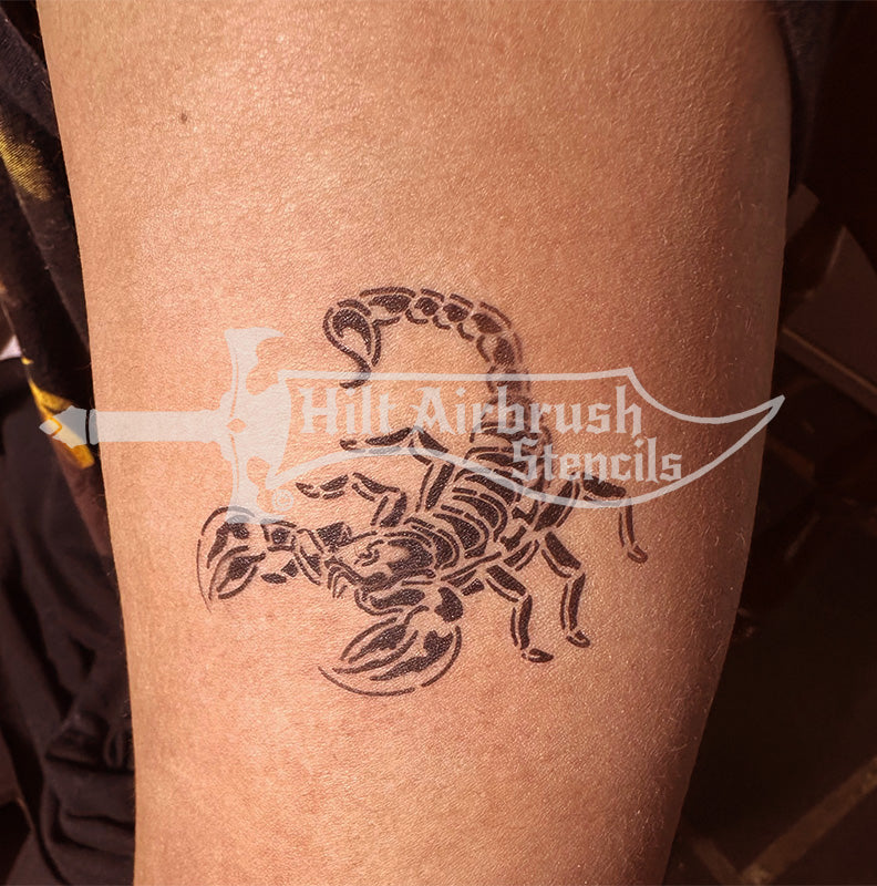 Scorpion tattoo design airbrushed on a person's arm created by Hilt Airbrush Stencils.