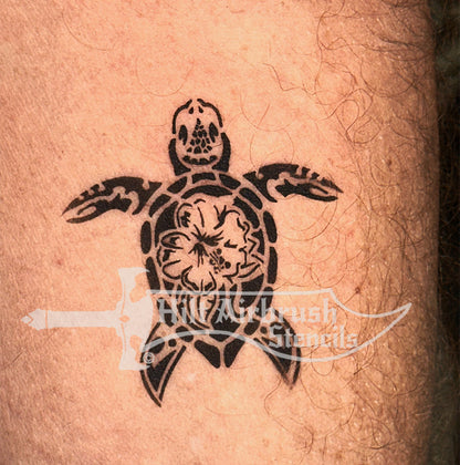 Airbrush tattoo of a sea turtle design on skin created with a stencil from Hilt Airbrush Stencils.