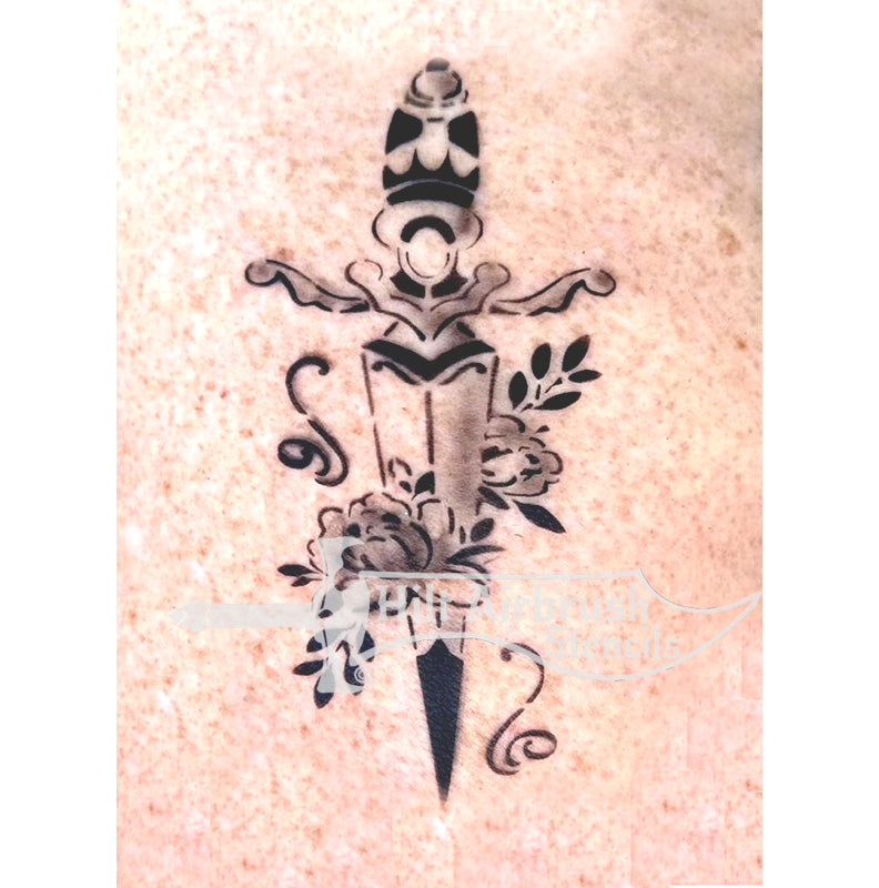Airbrush tattoo of dagger with floral elements on person's arm, created with a stencil from Hilt Airbrush Stencils.