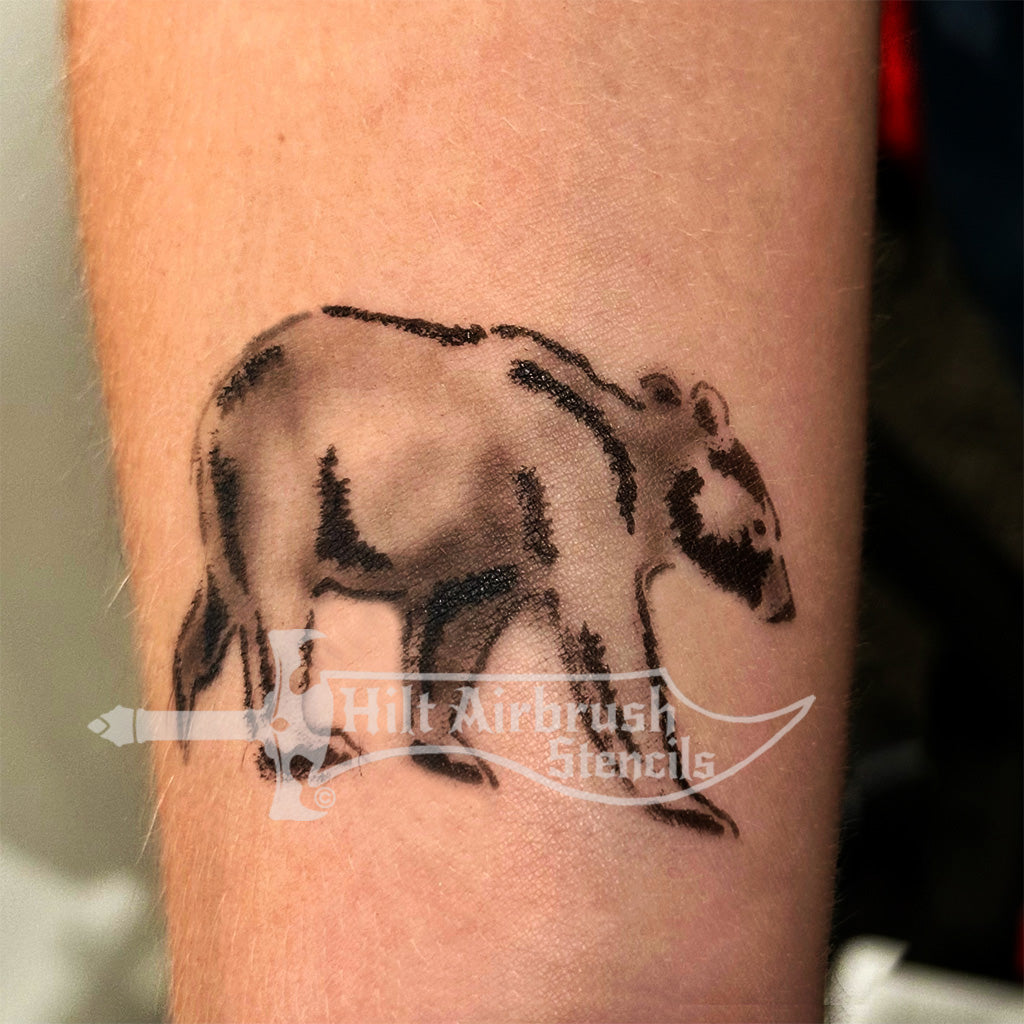 Tattoo of a bear airbrushed on a person's arm from the Hilt Airbrush Stencils collection.
